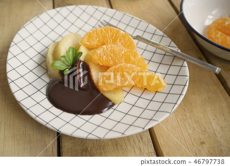 poached apples & fresh orange with chocolate sauce poached apples & fresh orange with chocolate sauce 46797738