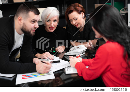 Smiling employees talking in workplace Smiling employees talking in workplace 46800236