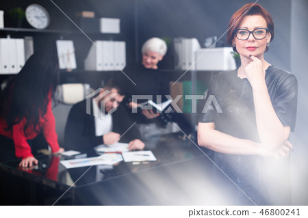 Businesswoman on background of Office workers discussing project 46800241