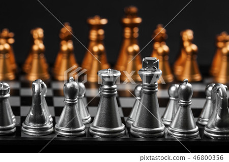 Abstract background. Gold and silver chess on black background. Abstract background. Gold and silver chess on black background. 46800356