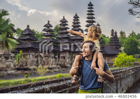 Dad and son tourists in Traditional balinese hindu Temple Taman Ayun in Mengwi. Bali, Indonesia Dad and son tourists in Traditional balinese hindu Temple Taman Ayun in Mengwi. Bali, Indonesia 46803456