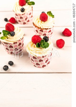 summer dessert of cupcakes and berries, food 46804717