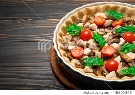 Traditional quiche tart in baking form with filling 46805348