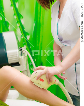 Woman getting laser treatment in beautician 46805459