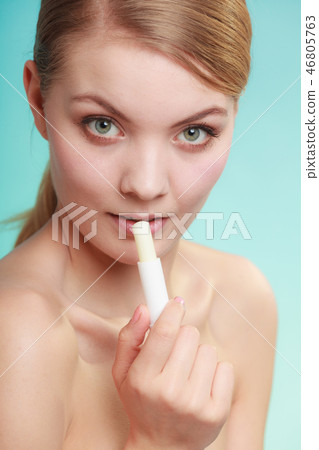 woman applying balsam for lips 46805763