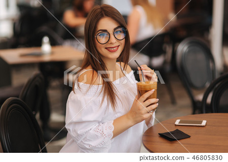 Stylish happy young woman wearing white shirt .She holds coffee. portrait of smiling girl in 46805830