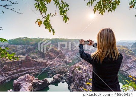 Woman take pictures in Gharial Sanctuary, India. Back view Woman take pictures in Gharial Sanctuary, India. Back view 46806454