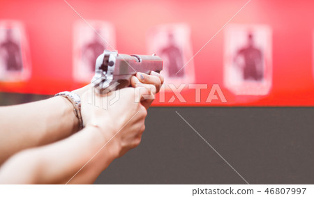 Woman Both Hands holding magnum gun, aiming target Woman Both Hands holding magnum gun, aiming target 46807997