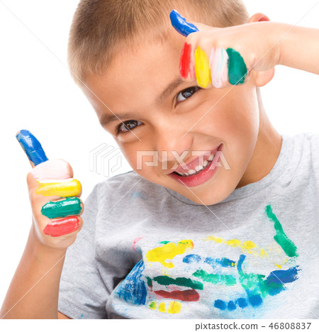 Portrait of a cute boy playing with paints Portrait of a cute boy playing with paints 46808837