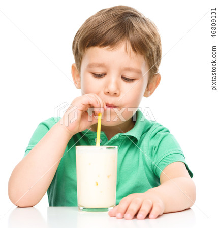 Cute little boy with a glass of milk 46809131