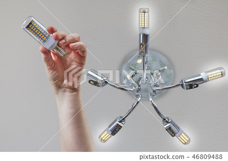 Installing LED lamp corn on the ceiling fixture. Installing LED lamp corn on the ceiling fixture. 46809488
