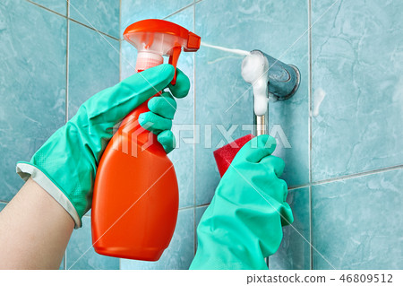 Hand in glove holds cleaning agent with foam spray Hand in glove holds cleaning agent with foam spray 46809512