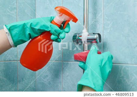 cleaner uses protective gloves for cleaning  cleaner uses protective gloves for cleaning  46809513