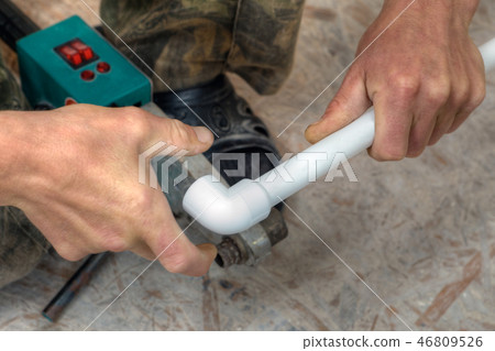 PPR pipes fusion welding, hands working closeup. PPR pipes fusion welding, hands working closeup. 46809526