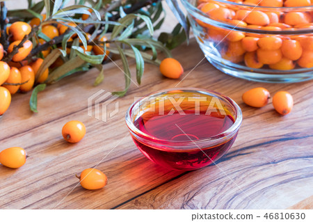 Sea buckthorn oil in a glass bowl Sea buckthorn oil in a glass bowl 46810630