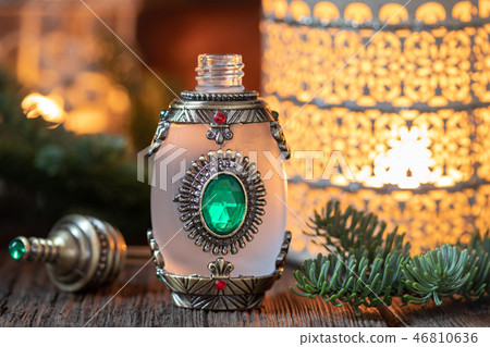 A bottle of fir essential oil with fir branches 46810636