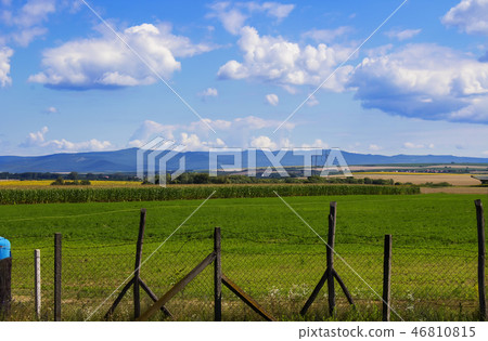 Fields against the backdrop of mountains  46810815