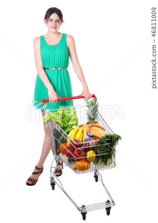woman in green dress with shopping grocery cart woman in green dress with shopping grocery cart 46811009