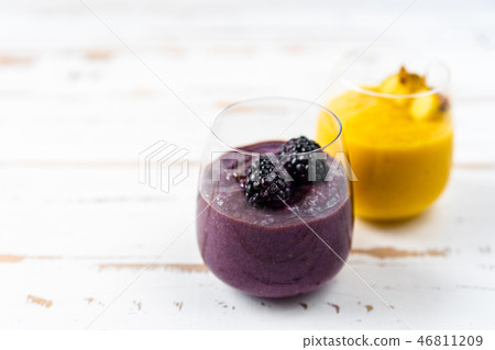 Colorful yellow and blue smoothie in two glasses Colorful yellow and blue smoothie in two glasses 46811209