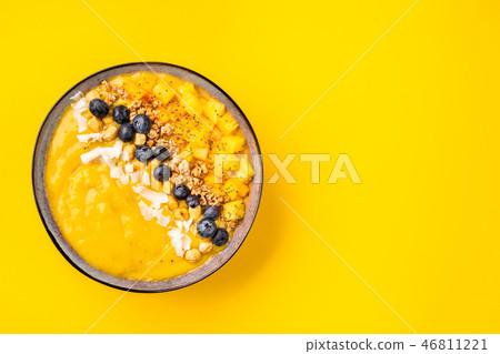 Top view of mango smoothie bowl with fruits 46811221