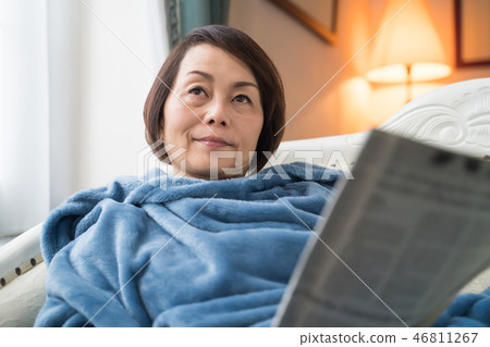 A woman reading a newspaper A woman reading a newspaper 46811267