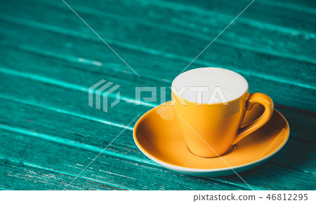 Cup of coffee on wooden table. Cup of coffee on wooden table. 46812295
