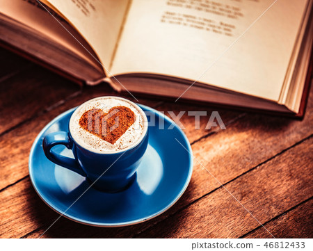 Cup of coffee with heart near book 46812433