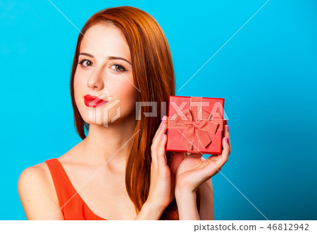 Smiling redhead woman with gift Smiling redhead woman with gift 46812942