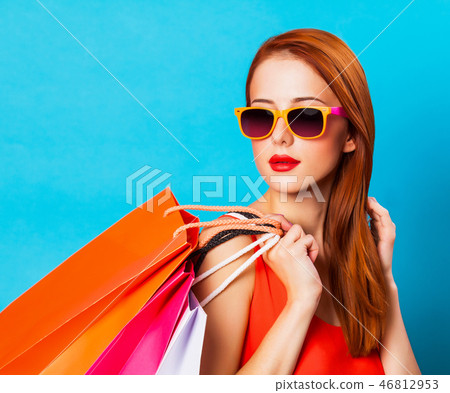 Style redhead woman holding shopping bags Style redhead woman holding shopping bags 46812953