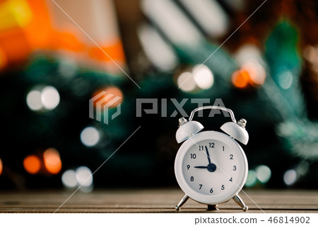 Alarm clock on wooden table with Christmas gifts Alarm clock on wooden table with Christmas gifts 46814902