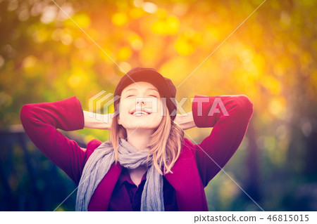 woman in red coat and hat have a rest in autum park 46815015