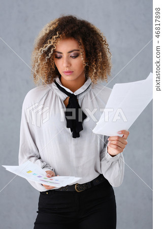 Beautiful black woman portrait. Holds paper documents 46817898