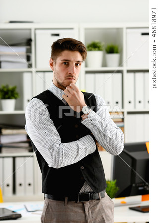 Handsome man in suit and tie stand in office Handsome man in suit and tie stand in office 46818971