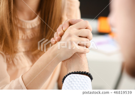 Woman and man in suit hold hands 46819539