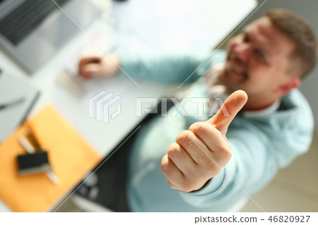 A young designer holds a pen from a tablet in his A young designer holds a pen from a tablet in his 46820927