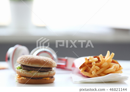Hamburger and french fries with headphones Hamburger and french fries with headphones 46821144