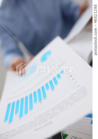 Male hands hold documents with financial statistics 46821298