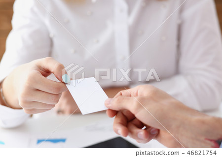 Female hand in suit give blank calling card to female Female hand in suit give blank calling card to female 46821754