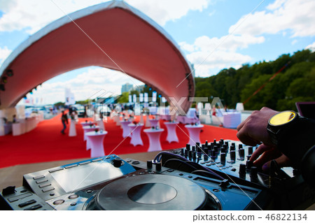 Dj hands on equipment deck and mixer. 46822134