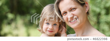Happy little smiling child in the arms of the mother 46822398