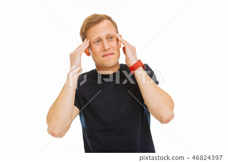 Depressed unhappy young man touching his temples Depressed unhappy young man touching his temples 46824397