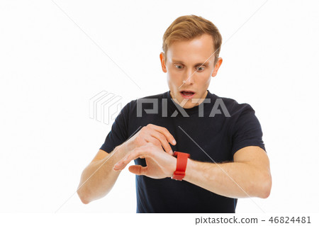 Nice blonde man checking the time on his watch 46824481