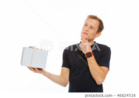 Nice thoughtful man holding a gift box Nice thoughtful man holding a gift box 46824516