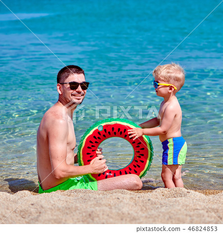 Toddler boy on beach with father 46824853