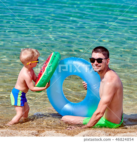 Toddler boy on beach with father 46824854