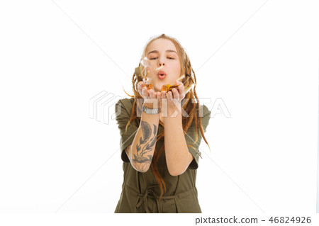 Pleasant attractive woman blowing at the decorations 46824926