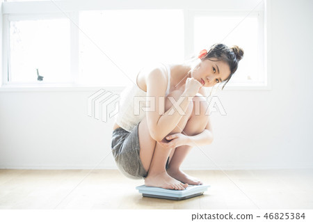 A woman on a scale A woman on a scale 46825384