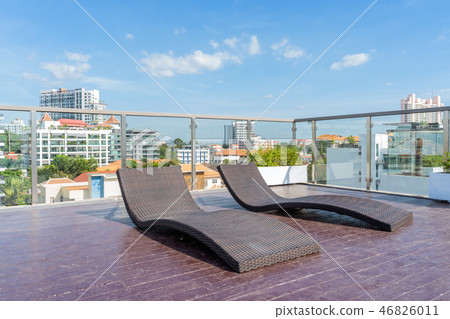 Sun loungers are located on the rooftop. 46826011