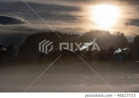 Smoke from the chimneys of a mountain village  46827553