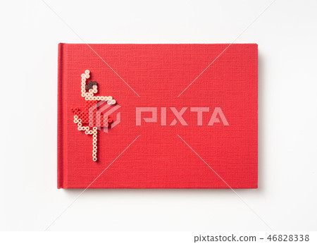Top view of red hardcover notebook and toy 46828338